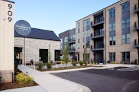 a parking lot in front of an apartment building