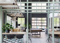 a modern living room with a wooden table and chairs
